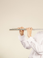 Flute music instrument in hands of flutist musician