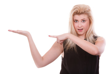 Fototapeta premium Blonde woman pointing with hands at copyspace