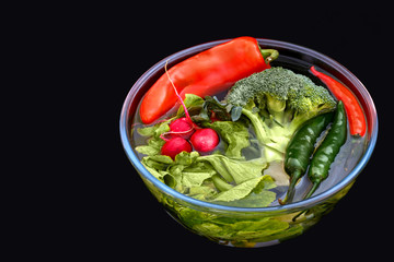 Fresh bio vegetables in wooden crate with salad,carrots,mushrooms,tomatoes,broccoli,radish,avocado,onions and garlic