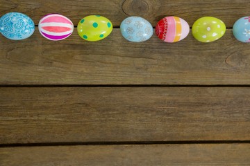 Painted Easter eggs on wooden surface