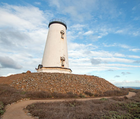 Fototapeta na wymiar Lighthouse at Piedras Blancas point at cloudy sunset on the Central Coast of California USA