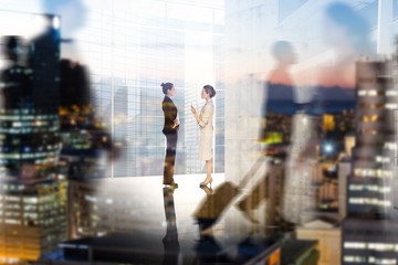 Composite image of businesswomen talking 