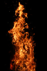 Tongues of flame of fire of orange-yellow color from burning firewood