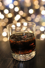 glass of cold alcohol drink with ice on table