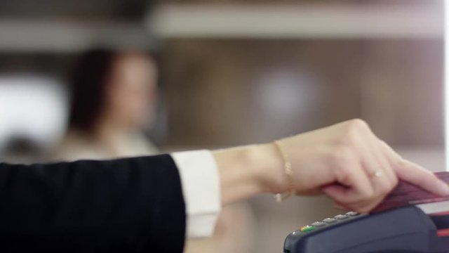 Credit card swipe through terminal machine and woman get a key