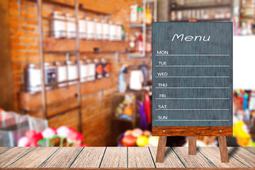 Wooden menu display sign, A Frame restaurant message board on wooden table, Blurred image background, Template mock up for adding your design and leave space beside frame for adding more text.