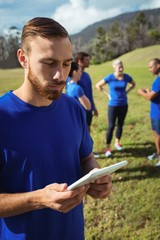Naklejka premium Man using digital tablet in boot camp