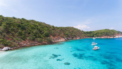 Blue water and Motor recreation boats on the tropical beach in the Racha Noi island Thailand