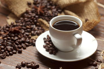 White cup of coffee with beans