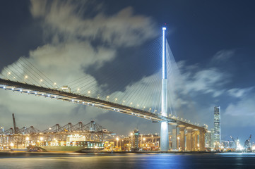 Fototapeta na wymiar Suspension bridge and cargo port in Hong Kong city