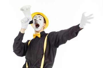 Portrait of a male mime artist, shouting or showing on a megaphone. Isolated on white background.