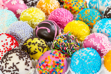 Different colorful cake balls with decorative sprinkles