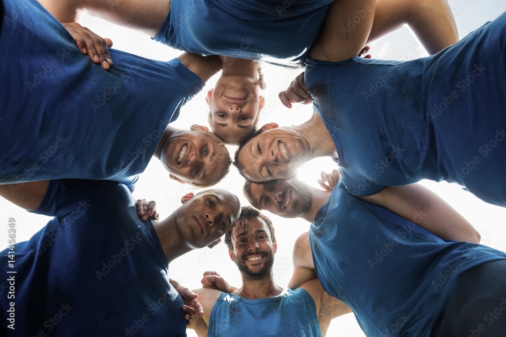 Wall mural fit people standing together and forming a hurdle