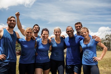 Group of fit people posing together in boot camp