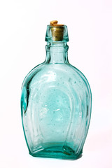 Old colourful bottles against a white background
