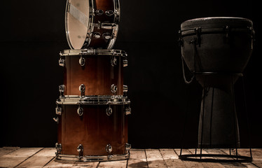 Fototapeta na wymiar musical percussion instruments on black background drum Bongo and snare