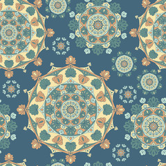 Vector seamless background pattern of circular ornament colored mandala repeating on blue background