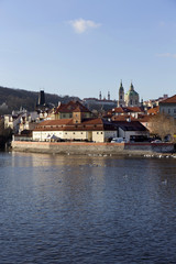 View on the autumn Prague St. Nicholas' Cathedral above River Vltava, Czech Republic