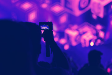 Crowd with arms outstretched at concert