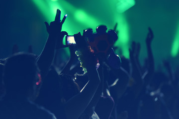 Crowd with arms outstretched at concert