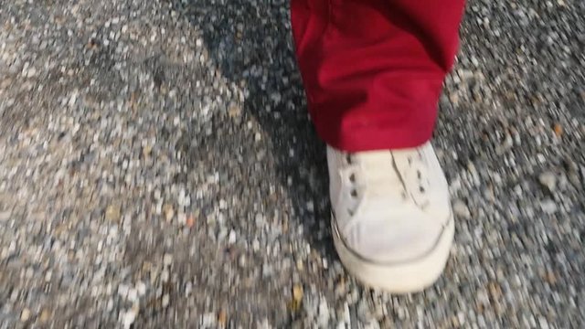 Close-up of feets of a man walking, slow motion