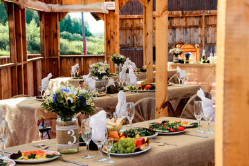 very nicely decorated wedding table with plates and serviettes.
