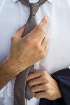 Businessman  Adjusting Tie Closeup