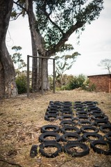 Obraz premium Boot camp with tyres obstacle course and fitness trial