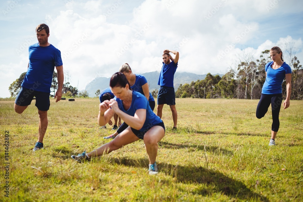 Wall mural fit people exercising in boot camp