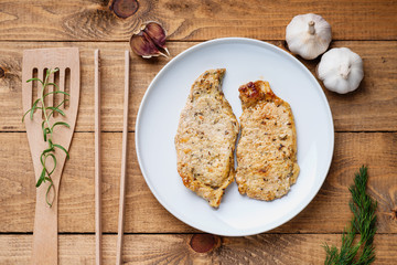 Fried pork meat, spatula and tongs
