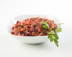 Russian beetroot salad vinaigrette White plate on checkered napkin on white background