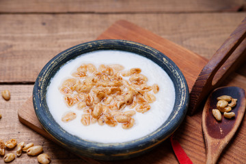Dish of cereal with milk and wooden spoon