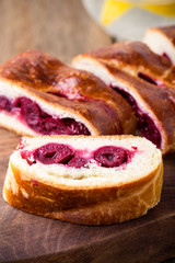 Homemade yeast dough cherry pie on wooden table
