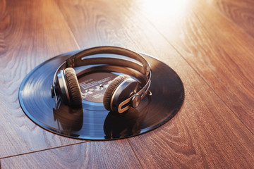 vinyl record and headphone over wooden table. Audio enthusiast,music lover or professional disc jockey equipmen.