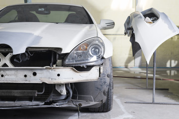 Auto body repair series : Closeup of white sport car waiting for repaint