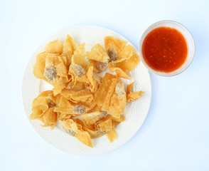 Deep Fried Wonton in white plate serve with sweet sauce on white background