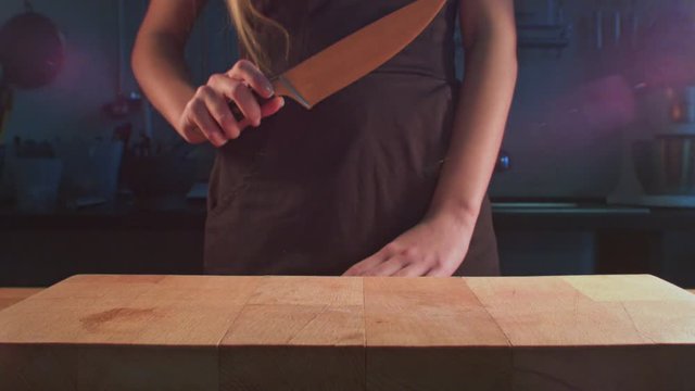 Woman take knife on kitchen. Knife killing concept. Woman knife killer. Woman hands take kitchen knife on wooden board