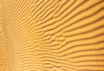 golden sand dunes with an irregular texture image
