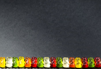 Little gummy bears on a dark background