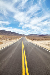 Fototapeta na wymiar Endless desert road in Death Valley, travel concept.