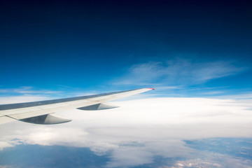 Fototapeta na wymiar The wing of an airplane flying in the sky
