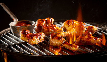 Marinated chicken wings grilling on a barbecue