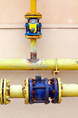 Gas pipe on the wall of ordinary dwelling house in Russia. Old gas pipeline outdoor.