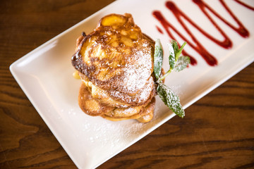 Fluffy Wholemeal Pancakes with sauce on a White Plate. View above