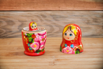 Matryoshkas, russian nesting dolls on wood background, mother, daughter and family women concept