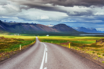 Asphalt road to the mountains. Iceland.
