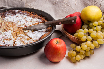 Cheesecake with fresh fruits on light marble background