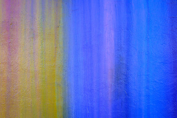Part of a stone wall with colorful paint marks, paint texture, paint sprayed wall with colorful stains and flowing paint