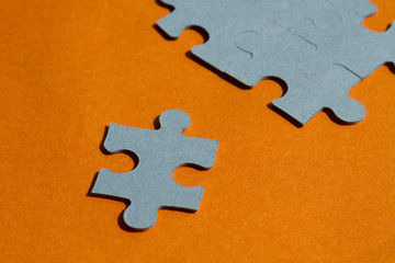 Fototapeta premium Jigsaw puzzle pieces on bright orange background