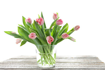 Pink tulips in a vase on a light background